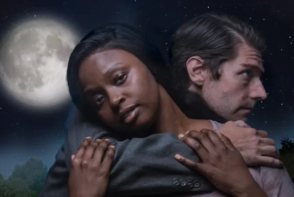 Actors embracing under full moon